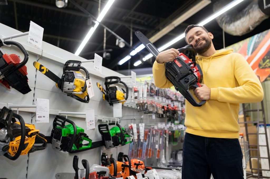 satisfied and happy customer hugging a petrol saw in a gardening equipment store